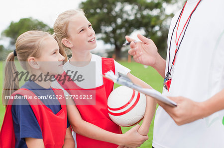 Coach talking to children on soccer team