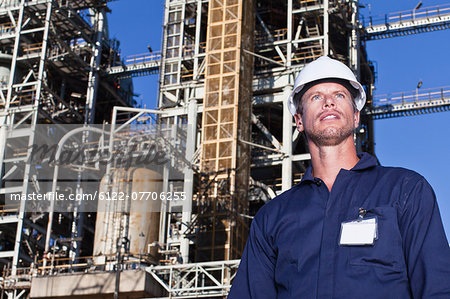 Worker standing at oil refinery