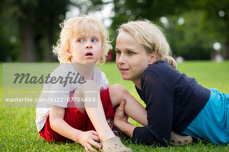 Mother and son sitting in grass