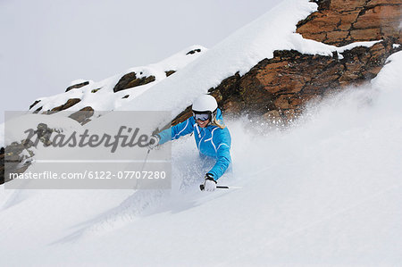 Skier coasting on snowy slope