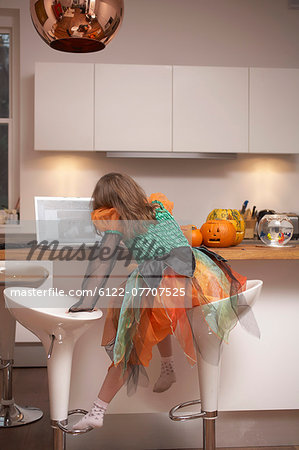Girl in Halloween costume in kitchen