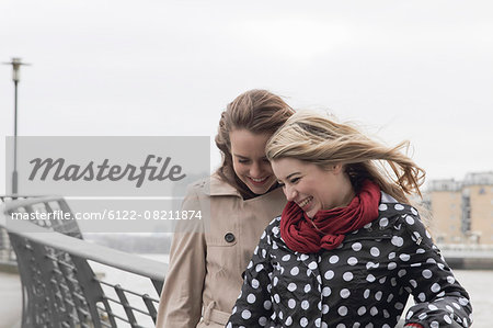 2 young windswept women laughing