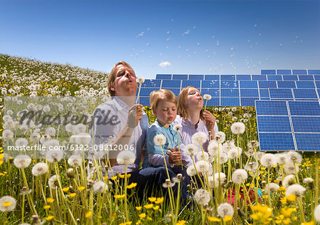 Father and children with solar panels