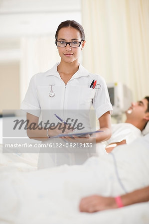Nurse with clipboard in hospital room