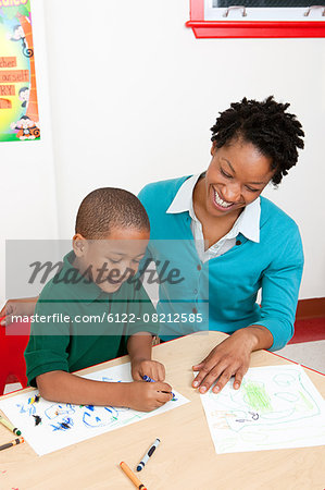 Teacher and boy drawing a picture