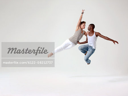 Two young men in mid air