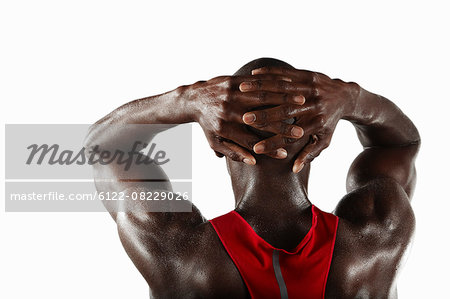 Athlete with hands folded behind head