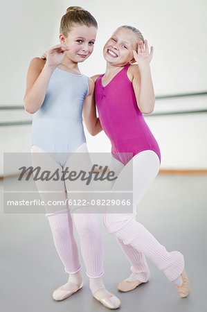 Ballet dancers waving in studio