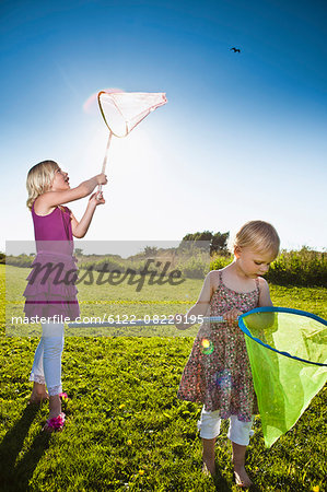 Girls playing with butterfly nets