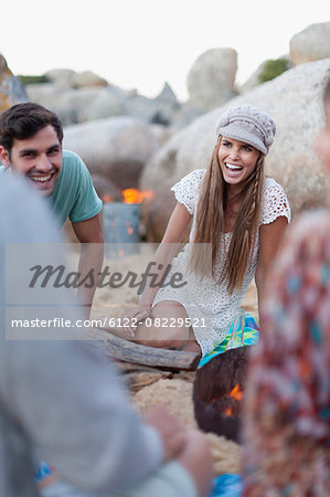 Friends sitting on beach together