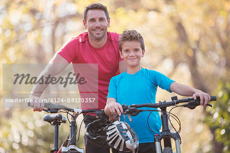 Portrait father and son bike riding
