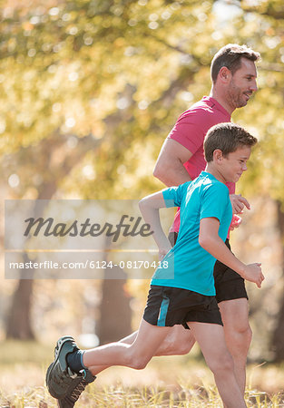 Father and son jogging in park