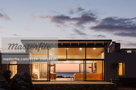 Illuminated luxury home under sky at dusk Illuminated luxury home under sky at dusk