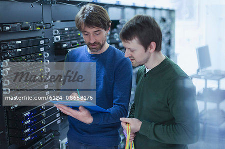 Server room technicians with clipboard Server room technicians with clipboard