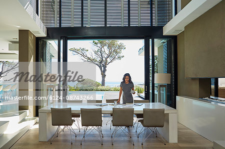 Businesswoman working at dining table in home showcase interior