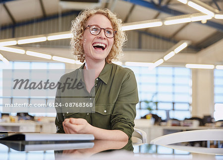 Laughing businesswoman in office