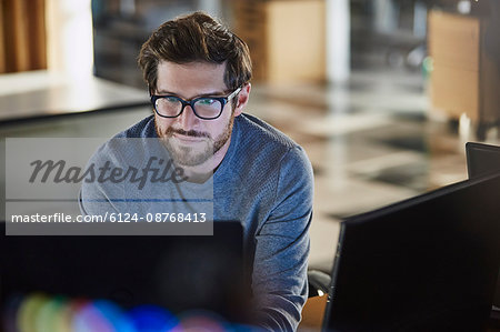 Businessman working at computer in office Businessman working at computer in office