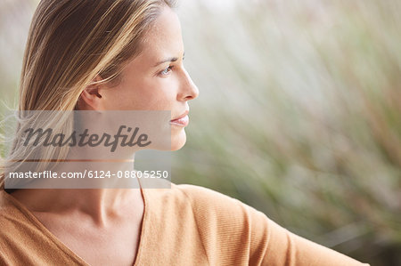 Close up pensive blonde woman looking away