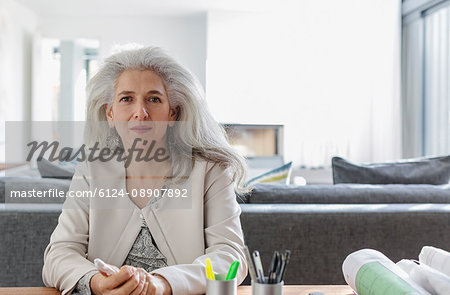 Portrait confident female architect in home office