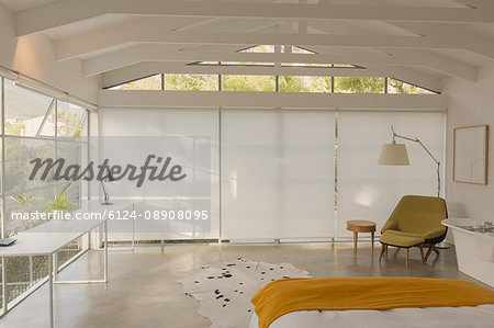 Modern, minimalist bedroom with vaulted wood beam ceiling