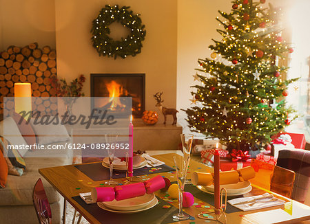 Ambient dining table, fireplace and Christmas tree in living room