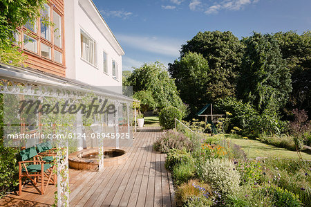 Home showcase luxury villa with sunny summer garden and deck