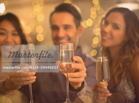 Portrait friends toasting champagne flutes