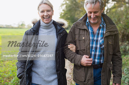 Happy Mature Couple Walking Arm In Arm In Park Stock Photo Masterfile Premium Royalty Free Code 6124