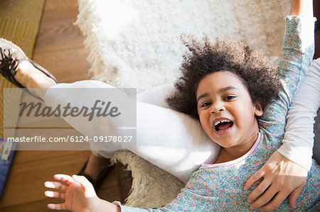 Portrait happy, carefree girl laying on mothers lap