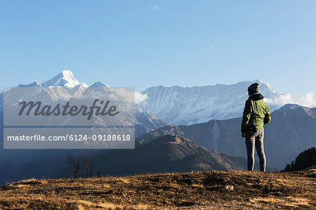 Solo female traveler looking at majestic mountain view, Jaikuni, Indian Himalayan Foothills