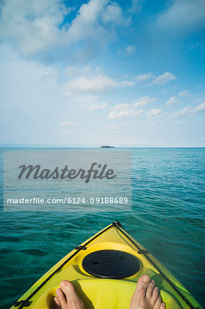 Personal perspective man kayaking on tranquil ocean, Maldives, Indian Ocean