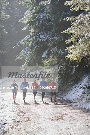 Family jogging in snowy woods