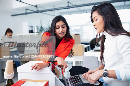 Businesswomen talking, working in new office