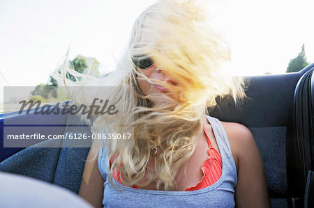 Sweden, Young woman in back of convertible