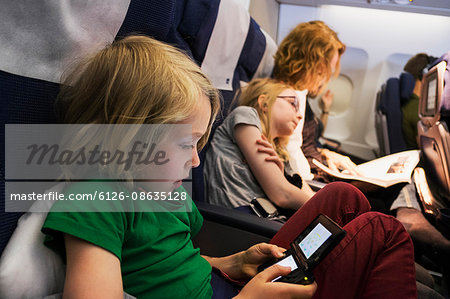 Sweden, Mother travelling by plane with children (6-7, 10-11)
