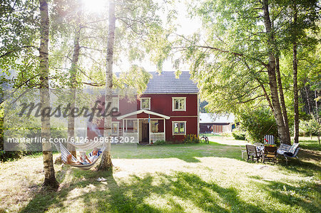 Sweden, Narke, Finnerodja, View man reading in hammock