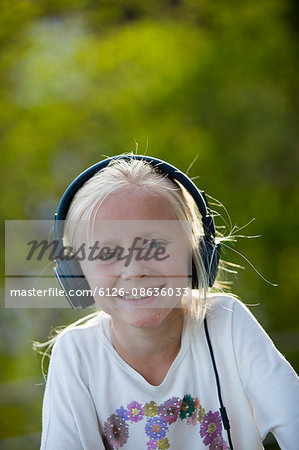 Sweden, Vastergotland, Portrait of girl (10-11) wearing headphones
