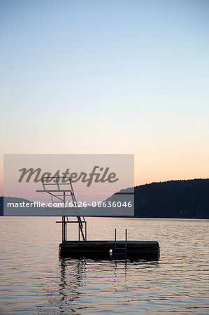 Sweden, Vastergotland, Lake Aspen, Platform on lake at sunset