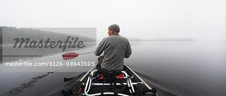 Sweden, Blekinge, Lake Halen, Man rowing on lake
