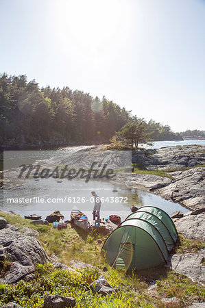 Sweden, West Coast, Bohuslan, Flato, Man camping on riverbank