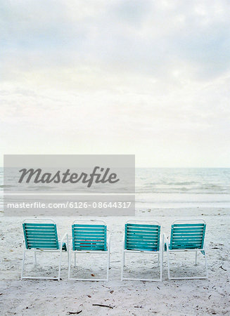 USA, Florida, Sanibel Island, Four empty folding chairs on beach