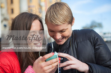 Sweden, Stockholm, Ostermalm, Two women listening to music