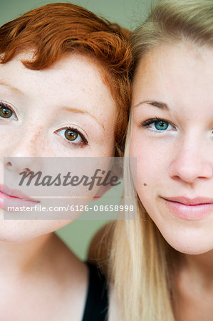 Portrait of redhair young woman and blonde teenage girl (16-17)