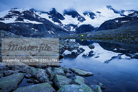 Men camping in snowy mountain landscape at Jotunheimen