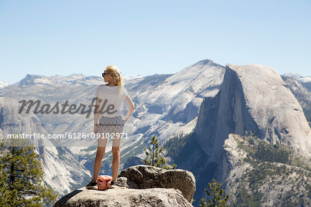 Girl looking at view with Sentinel Dome and Yosemite Falls