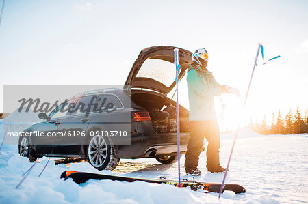 Man by a car with skiing equipment in Osterdalen, Norway