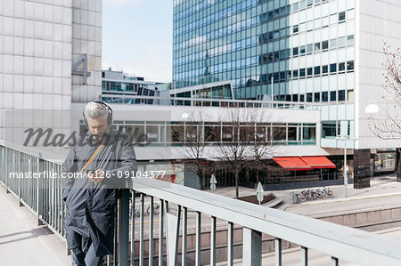 Man on smart phone on street in Stockholm, Sweden
