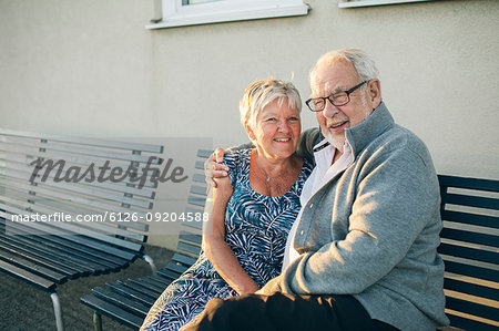 Portrait of senior couple hugging on bench