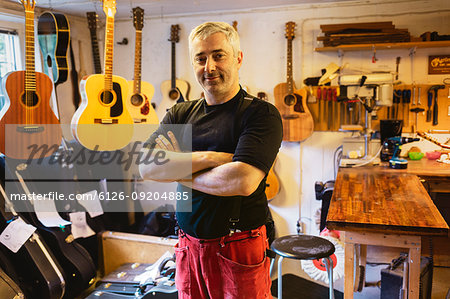 Portrait of craftsman in guitar making workshop