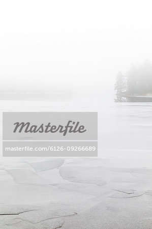 Fog on frozen Stora Skiren lake in Finspang, Sweden